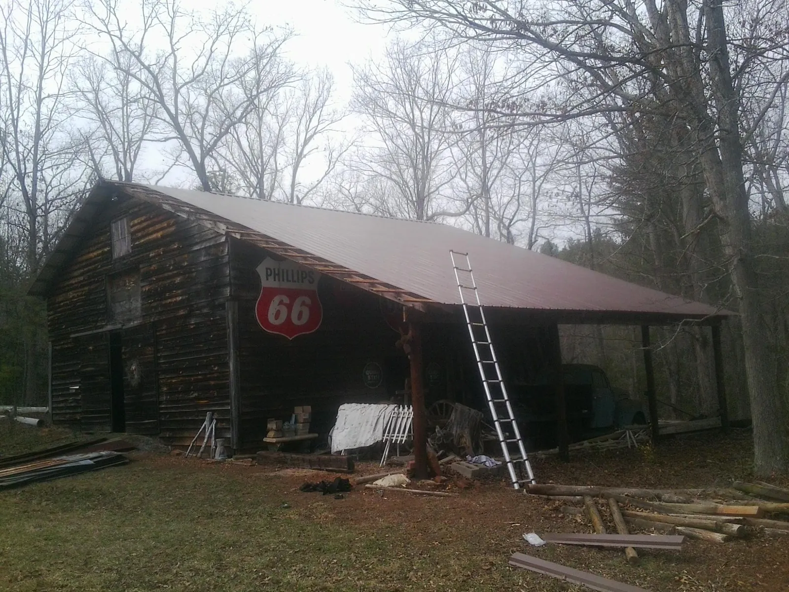 New metal roof on an open sided timber barn with a vintage sign in Callahan