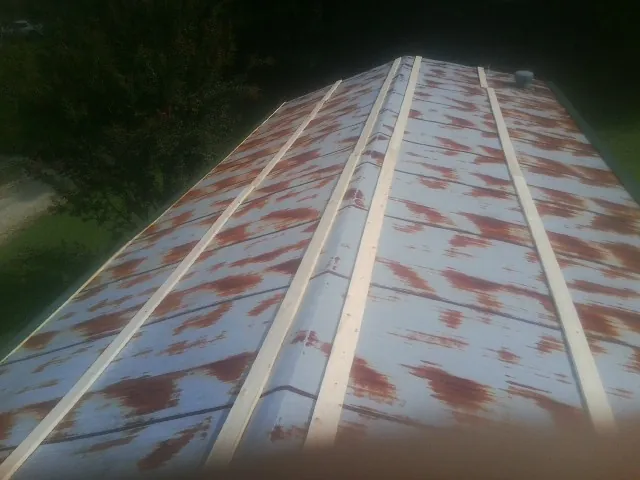 Rusted metal roof panels with new wood purlins before replacement — Storm Damage Roof Repair in Callahan by Roofing Brothers